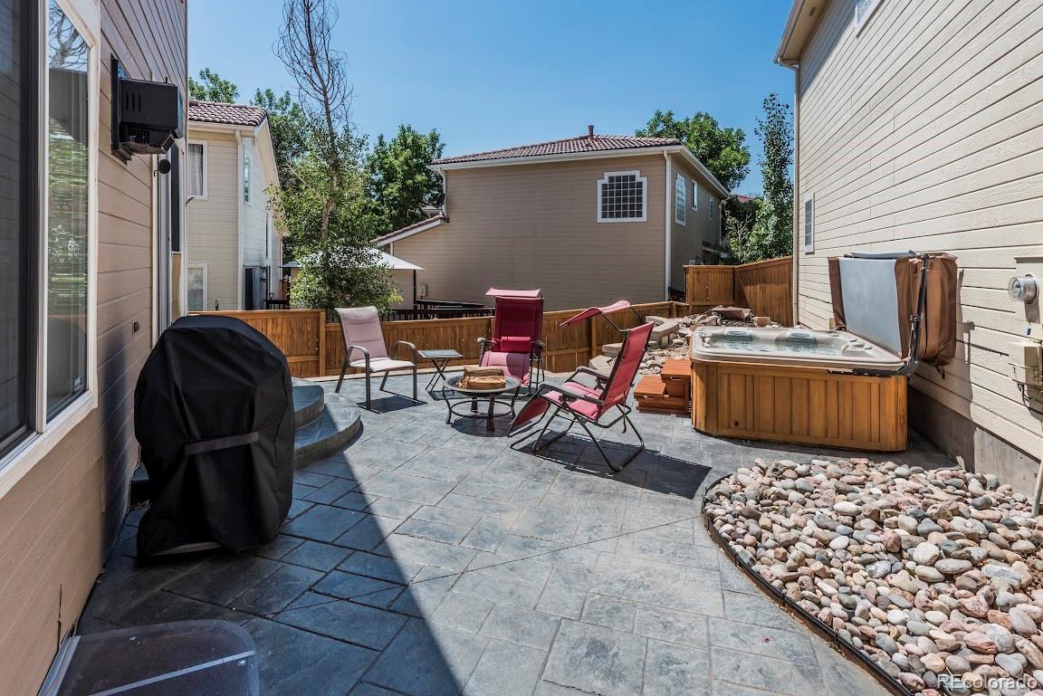 1279 Braewood Avenue Highlands Ranch, CO 80129 - Photo 19 of 20 a view of a chairs and table in the back yard of the house