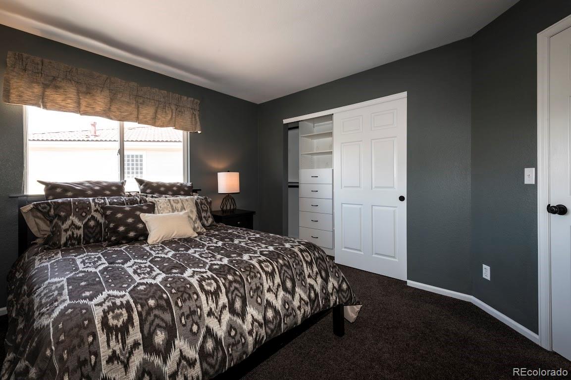 1279 Braewood Avenue Highlands Ranch, CO 80129 - Photo 5 of 20 a bed sitting in a bedroom next to a window