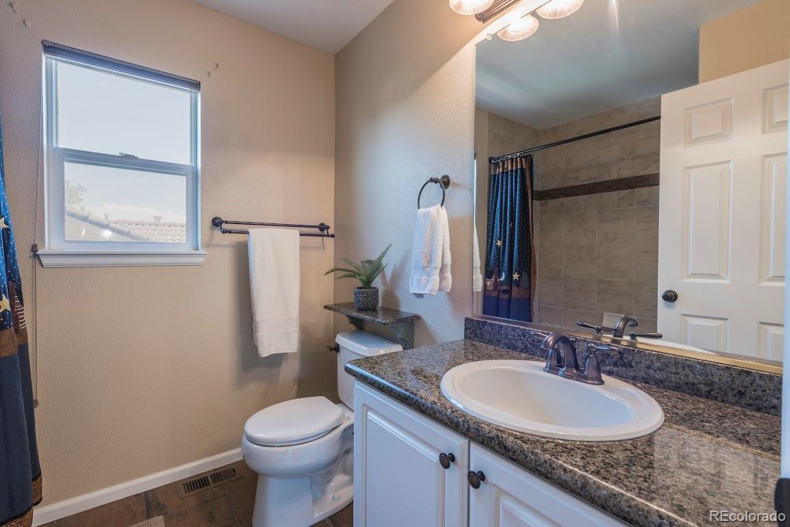 1279 Braewood Avenue Highlands Ranch, CO 80129 - Photo 6 of 20 a bathroom with a granite countertop toilet sink and mirror