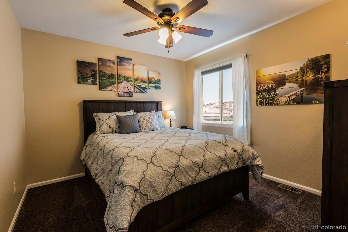 1279 Braewood Avenue Highlands Ranch, CO 80129 - Photo 7 of 20 a bed sitting in a bedroom next to a window