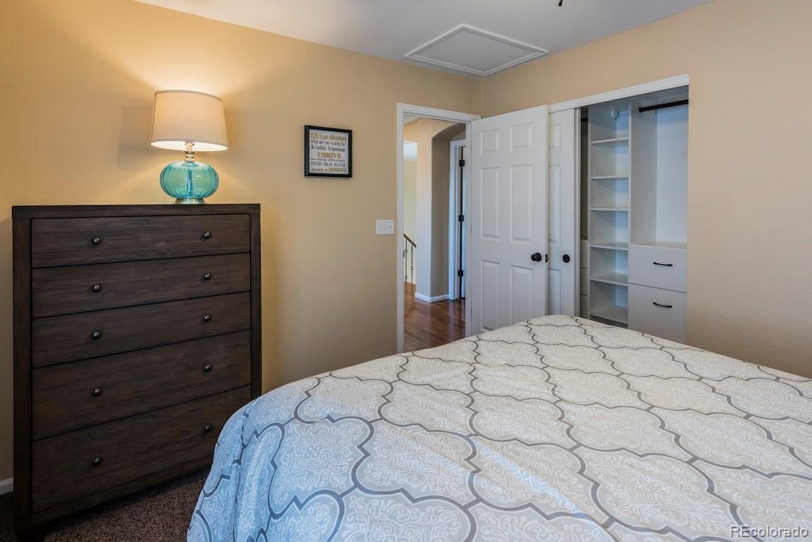 1279 Braewood Avenue Highlands Ranch, CO 80129 - Photo 8 of 20 a bedroom with a bed and a dresser