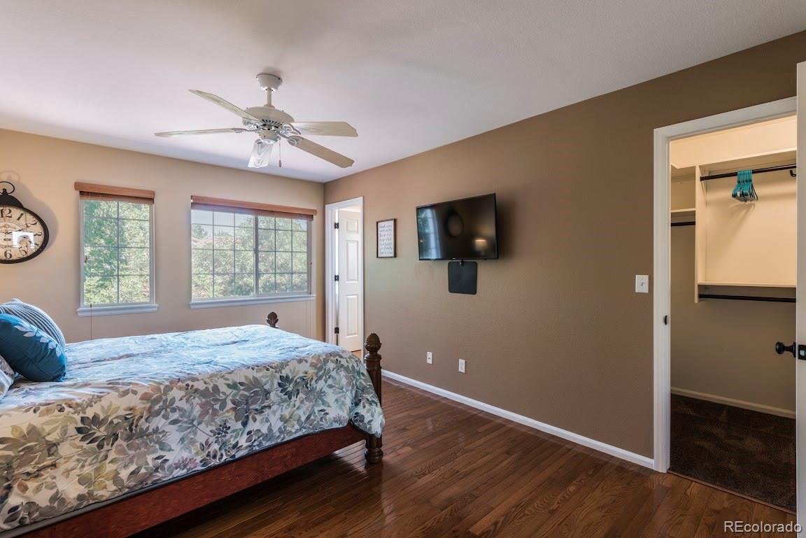 1279 Braewood Avenue Highlands Ranch, CO 80129 - Photo 9 of 20 a bedroom with a large bed a flat tv screen and dresser