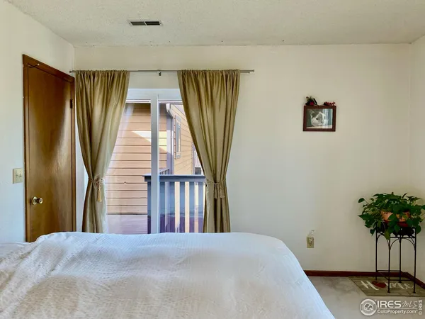 a bedroom with a bed and a potted plant