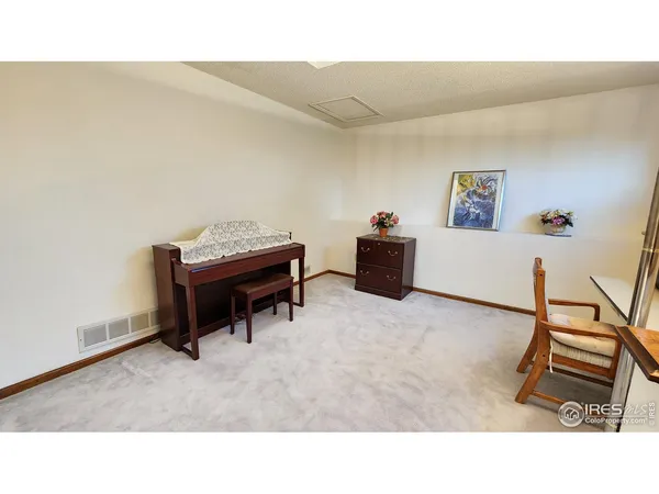a living room with furniture and a dresser
