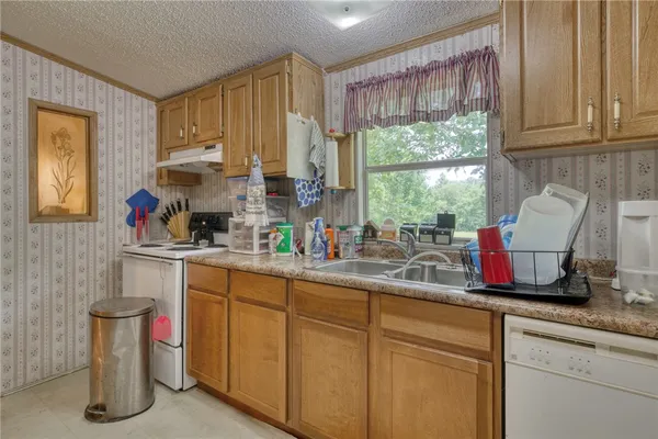 a kitchen with a sink cabinets and window