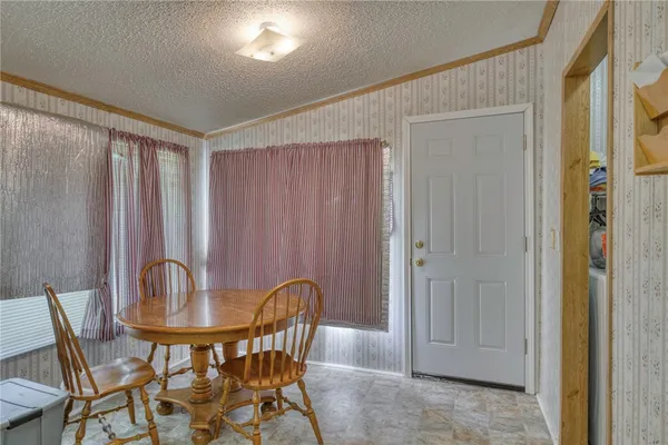 a view of a dining room with furniture and window