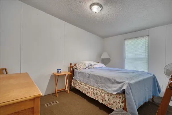 a bedroom with a bed and a table in it