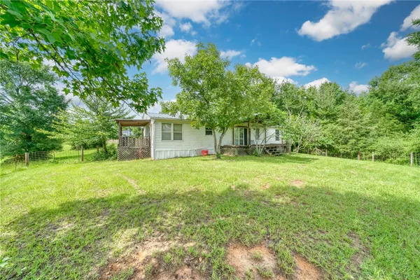 a view of a house with yard and tree s
