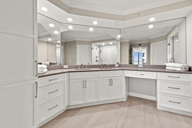 a spacious bathroom with a granite countertop sink mirror and cabinets