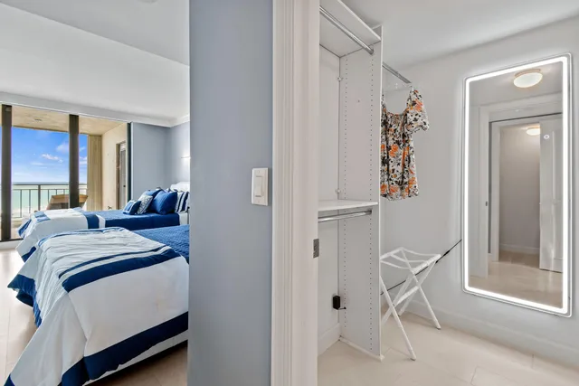 a bedroom with a bed and a chair