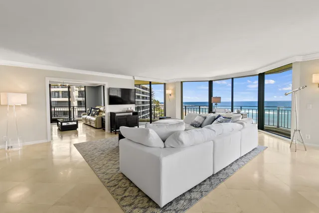 a living room with furniture large window and flat screen tv
