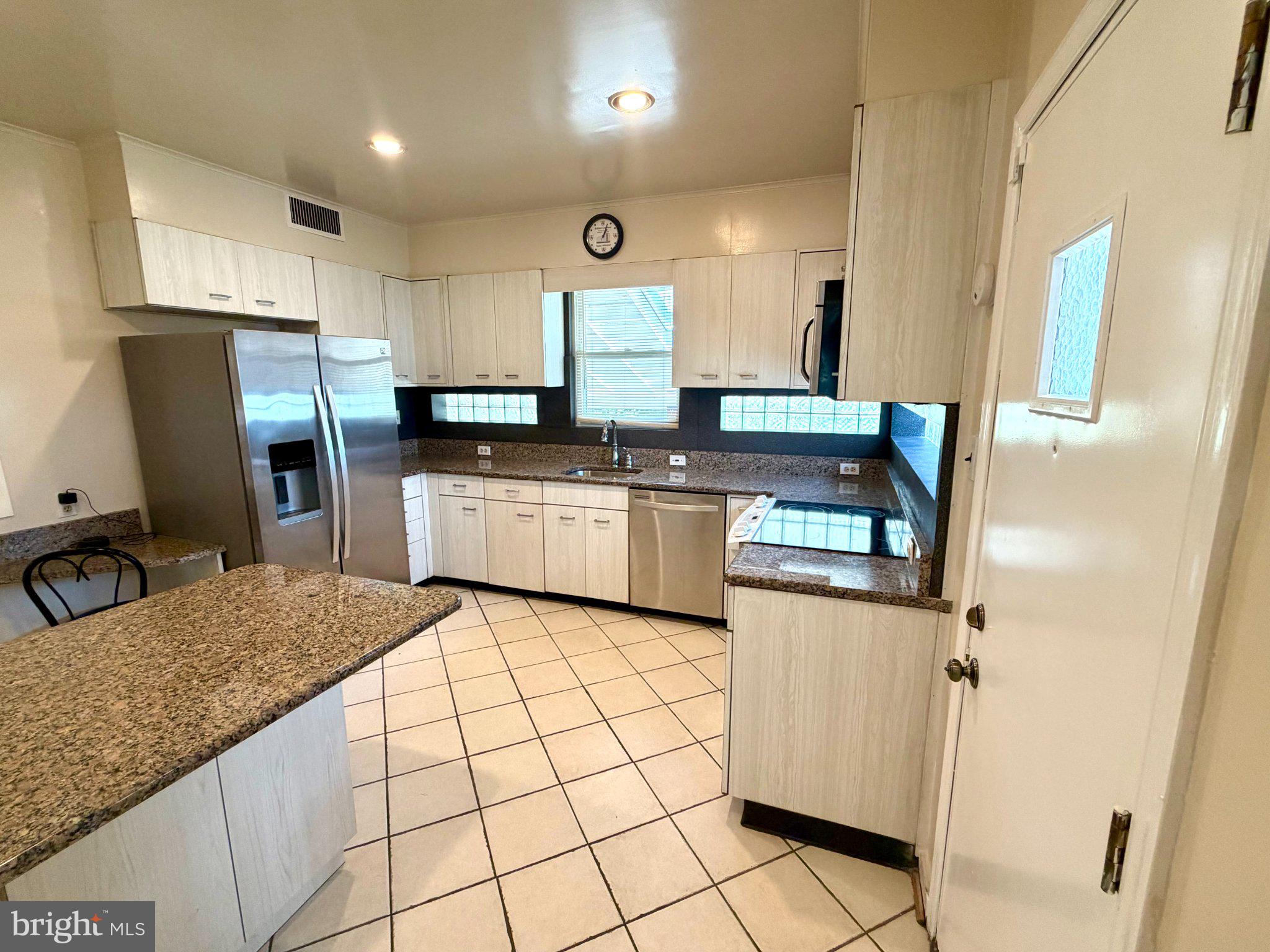 6318 Winner Avenue Baltimore, MD 21215 - Photo 18 of 75 a kitchen with stainless steel appliances granite countertop a sink stove and refrigerator