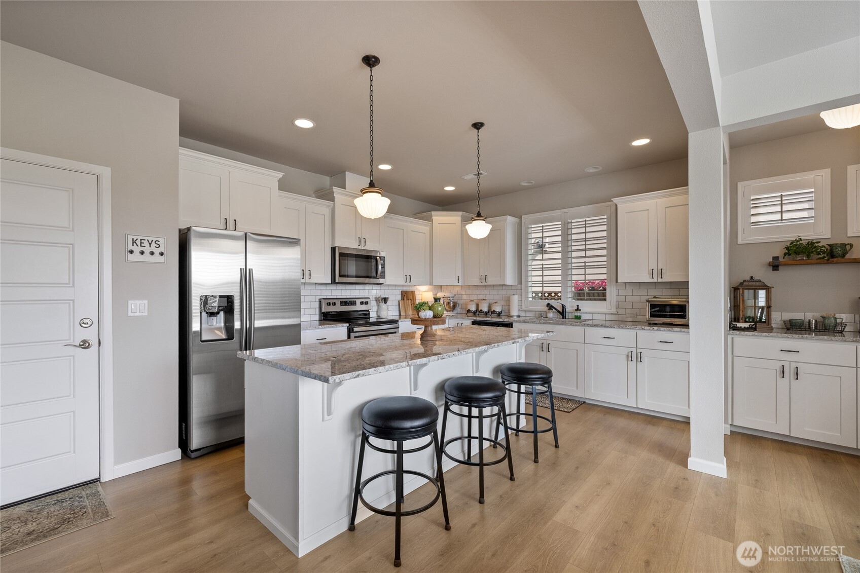 5641 Parquet Way Southeast Lacey, WA 98513 - Photo 13 of 39 a kitchen with refrigerator a sink and wooden floor