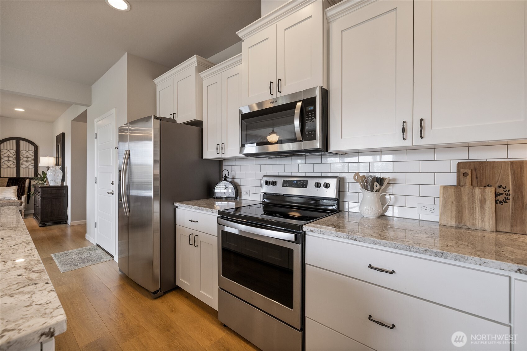 5641 Parquet Way Southeast Lacey, WA 98513 - Photo 16 of 39 a kitchen with stainless steel appliances granite countertop white cabinets a refrigerator a stove a sink and dishwasher