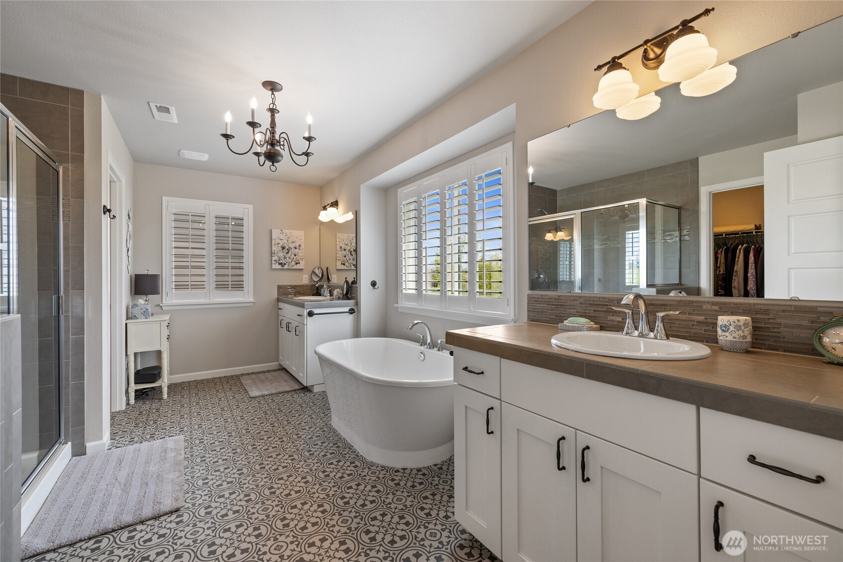 5641 Parquet Way Southeast Lacey, WA 98513 - Photo 25 of 39 a spacious bathroom with a double vanity sink a mirror a bathtub and a window