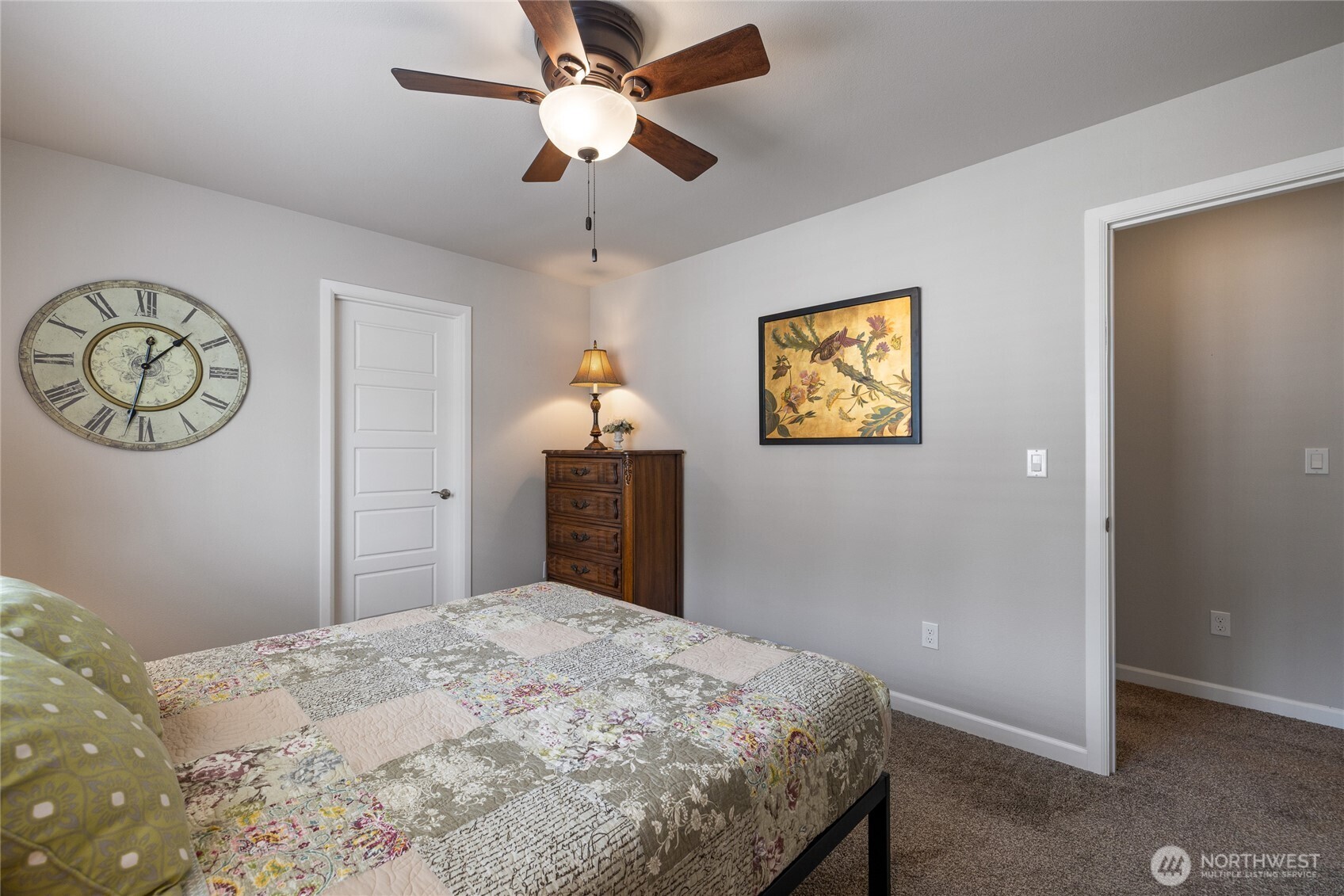 5641 Parquet Way Southeast Lacey, WA 98513 - Photo 30 of 39 a bedroom with a large bed and a chandelier