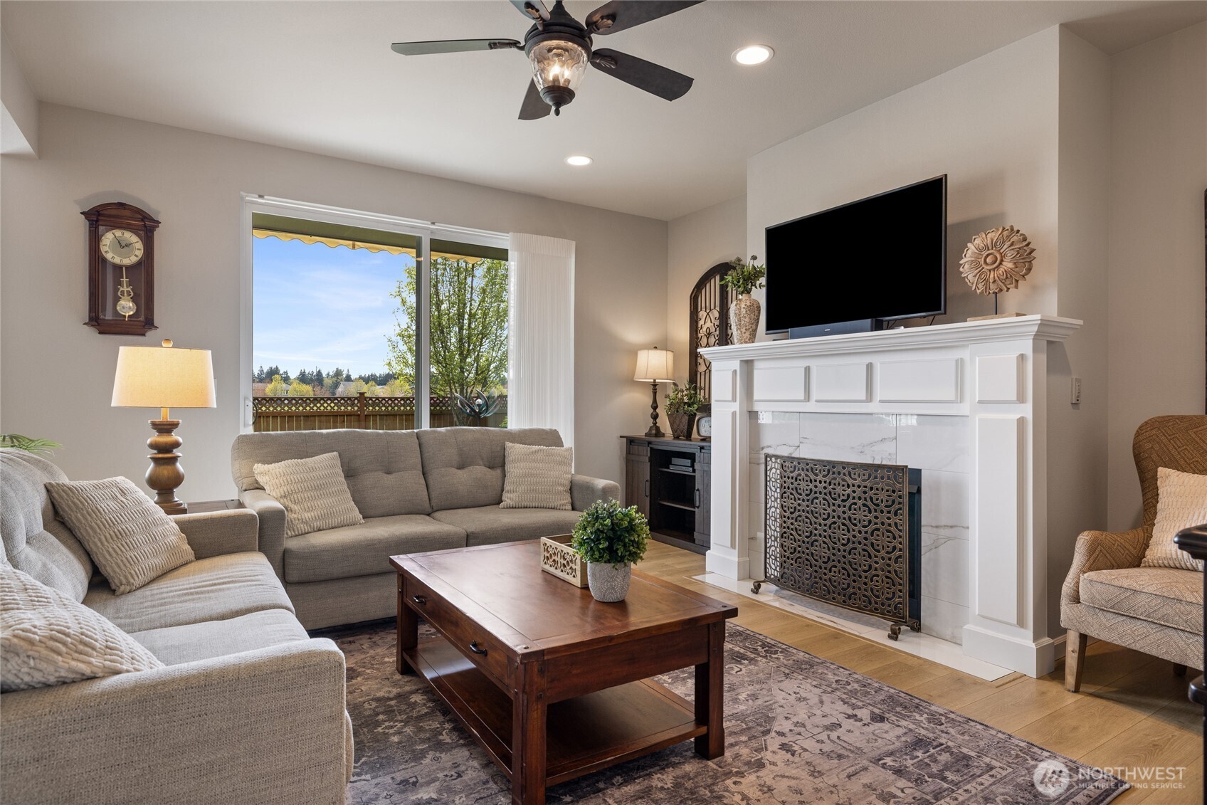 5641 Parquet Way Southeast Lacey, WA 98513 - Photo 10 of 39 a living room with furniture a fireplace and a flat screen tv