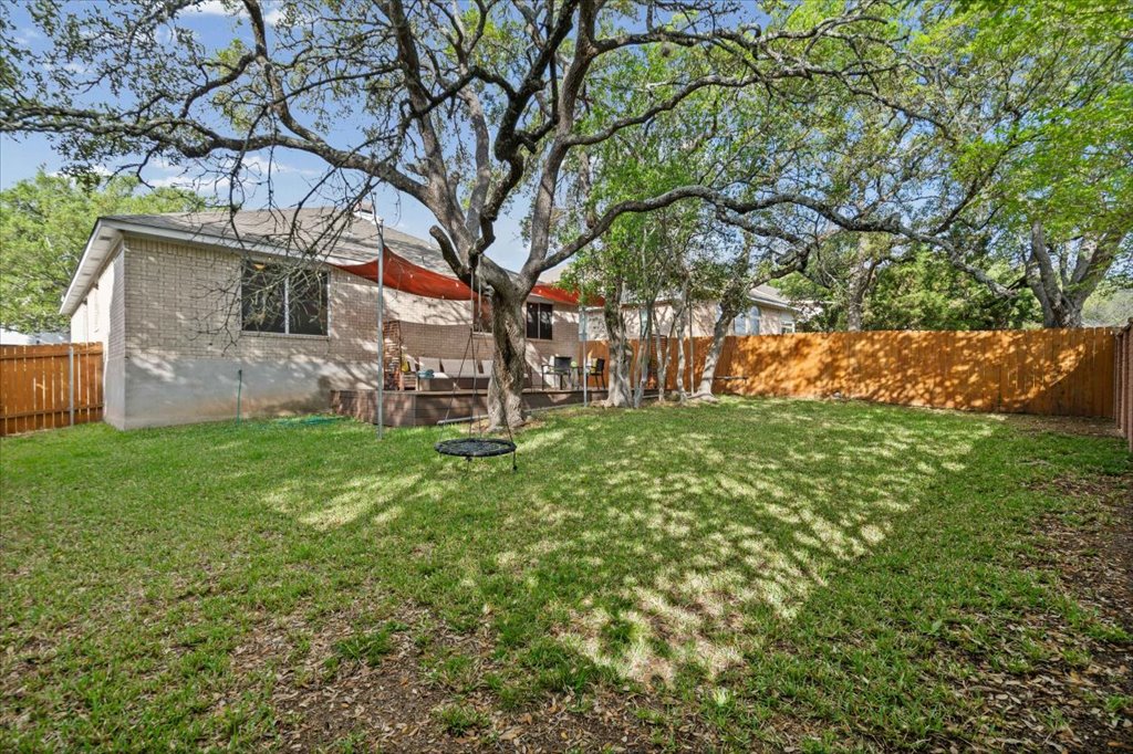 5948 Lomita Verde Circle Austin, TX 78749 - Photo 19 of 31 a view of a house with a backyard