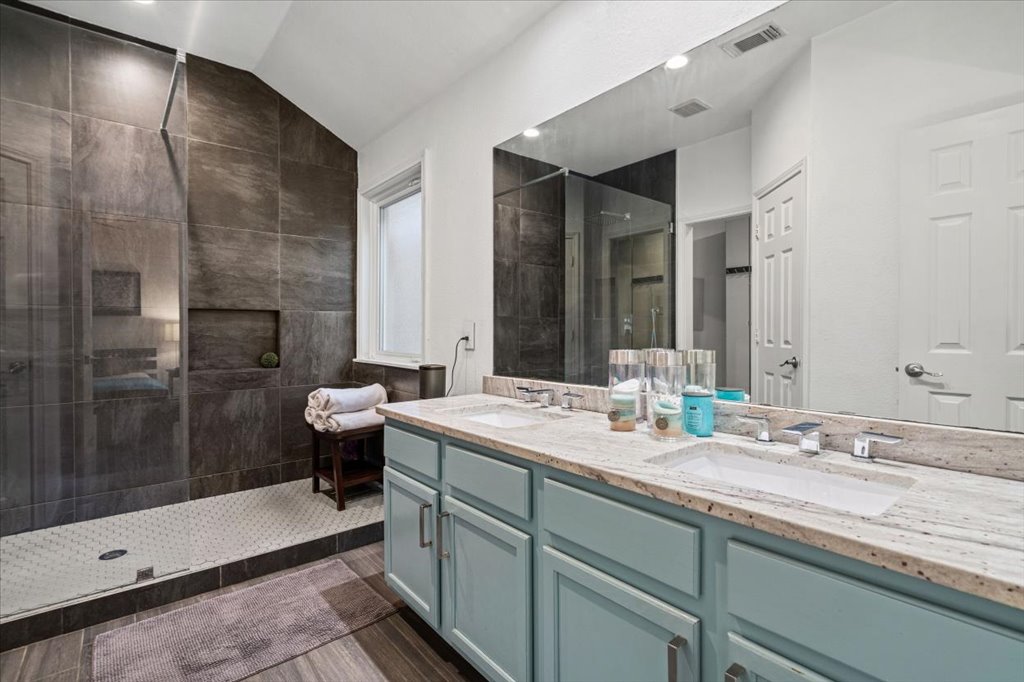 5948 Lomita Verde Circle Austin, TX 78749 - Photo 22 of 31 a bathroom with a double vanity sink toilet and shower