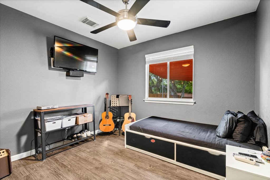 5948 Lomita Verde Circle Austin, TX 78749 - Photo 28 of 31 a bed room with furniture and a flat screen tv