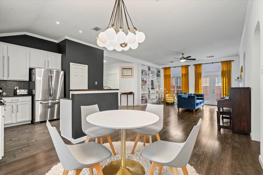 5948 Lomita Verde Circle Austin, TX 78749 - Photo 9 of 31 a view of a dining room with furniture a chandelier and wooden floor