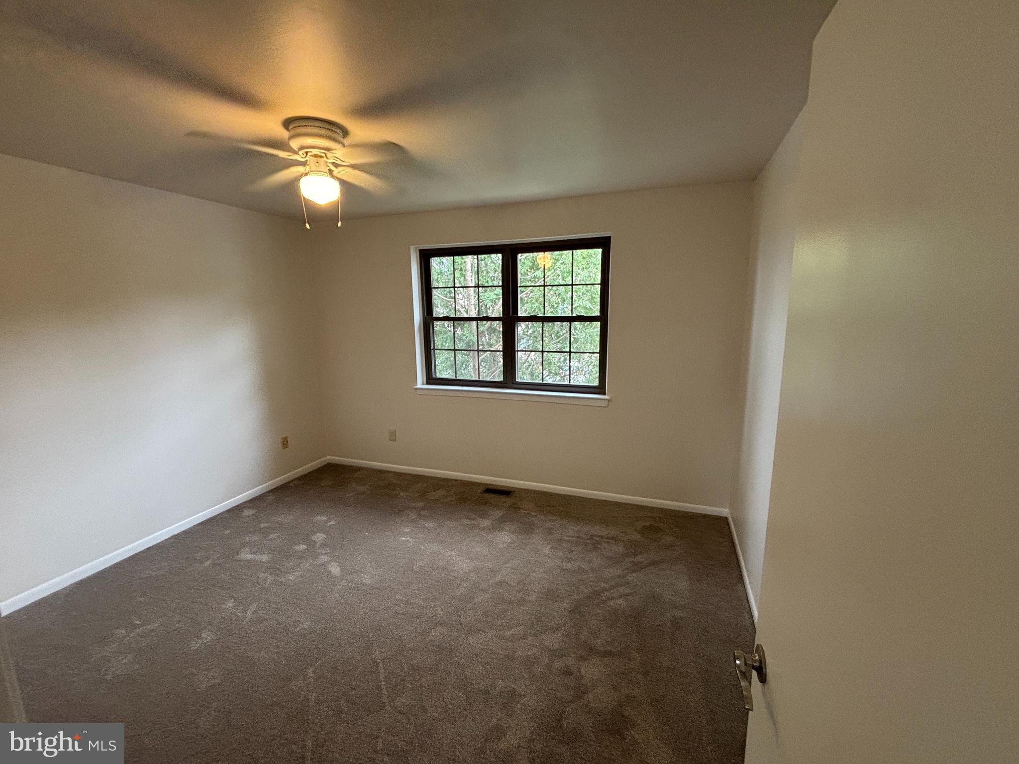 1460 Tarleton Place Warminster, PA 18974 - Photo 7 of 12 an empty room with a chandelier fan and windows