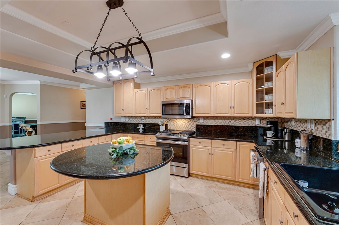 14396 Nautical Lane Helendale, CA 92342 - Photo 14 of 43 a kitchen with a sink a stove and chairs in it
