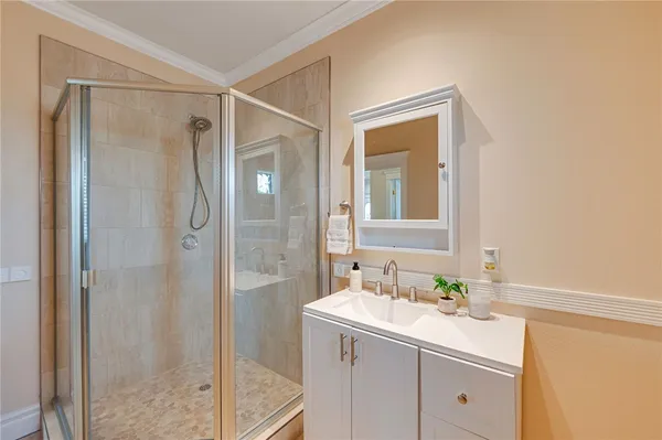 a bathroom with a shower sink and mirror