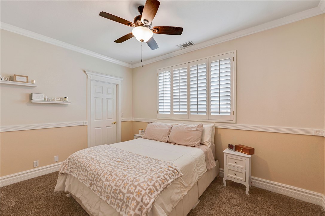 14396 Nautical Lane Helendale, CA 92342 - Photo 26 of 43 a bedroom with a large bed and a ceiling fan