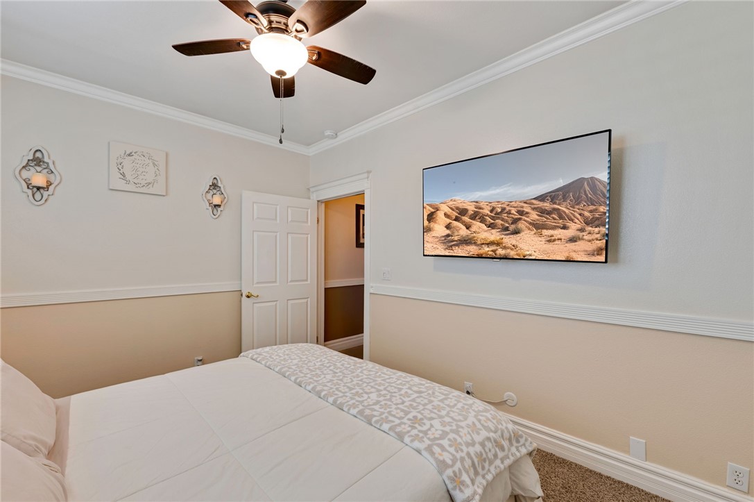 14396 Nautical Lane Helendale, CA 92342 - Photo 27 of 43 a bedroom with a bed and a chandelier