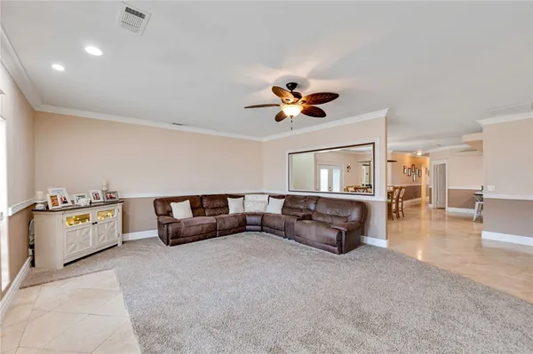 a living room with furniture and kitchen view