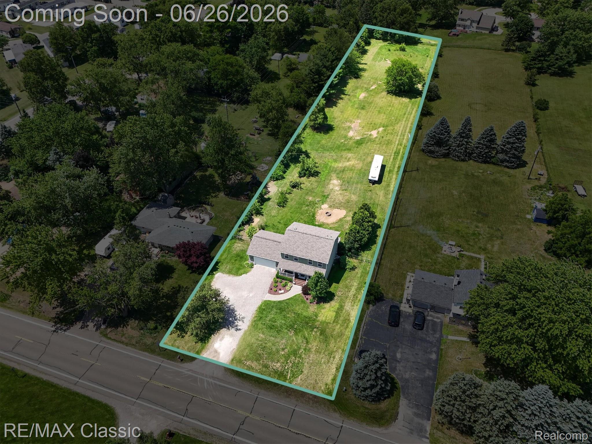 3205 North Milford Road Highland, MI 48357 - Photo 52 of 53 Expansive lot featuring a residential structure, a paved driveway, and mature landscaping