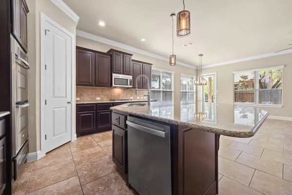 a kitchen with stainless steel appliances granite countertop a refrigerator and a sink