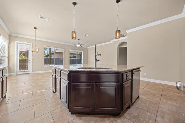 a kitchen with stainless steel appliances granite countertop a sink and a wooden floor