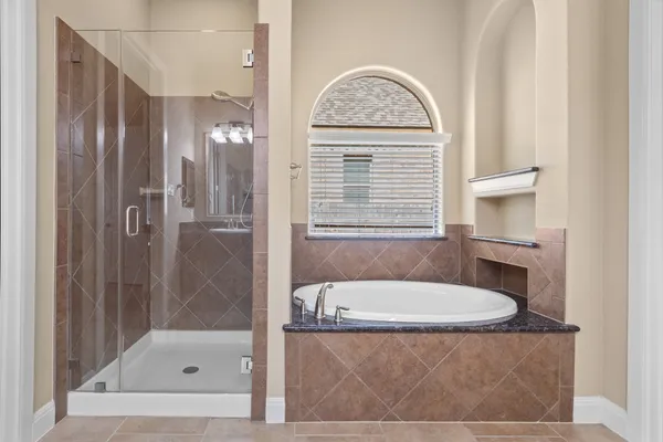 a bathroom with a granite countertop sink a large mirror and a