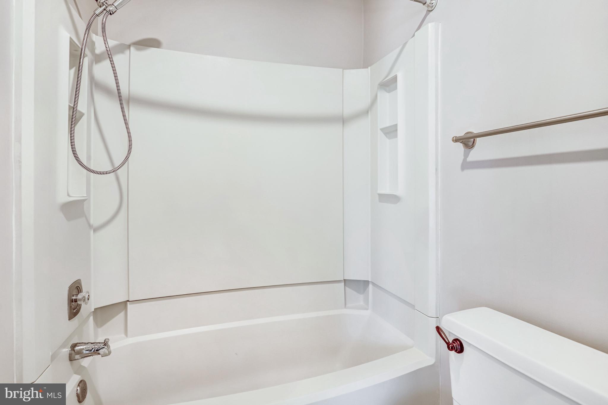 1953 Lakeport Way Reston, VA 20191 - Photo 33 of 60 a bathroom with a bath tub with a shower