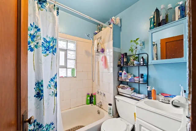 a bathroom with a sink mirror vanity and toilet