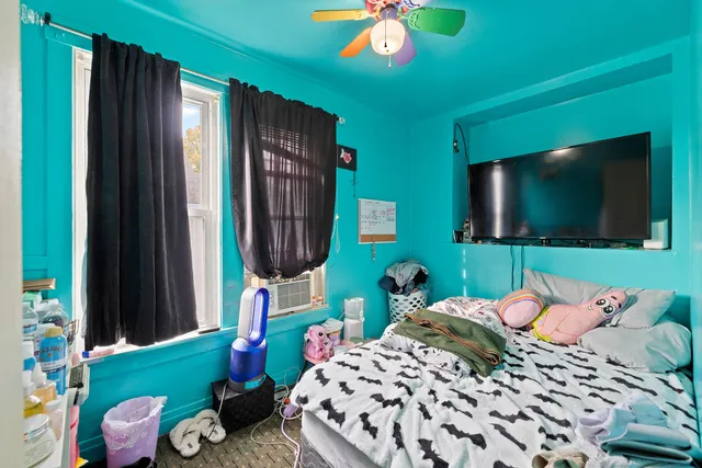 a bedroom with a bed and flat tv screen