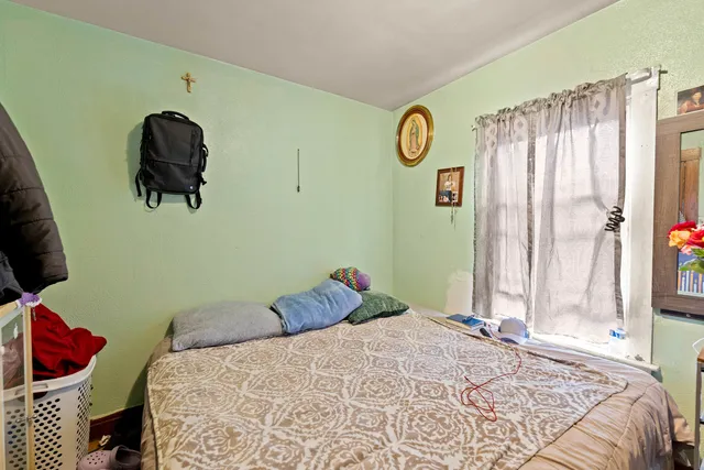 a bedroom with a bed and a chandelier
