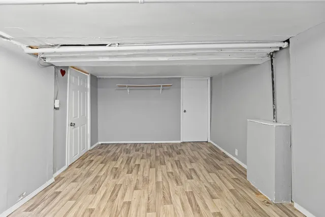 a view of a room with wooden floor