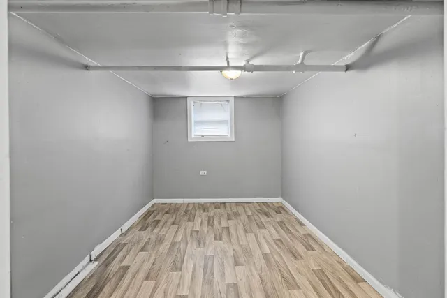 an empty room with a hardwood and ceiling fan