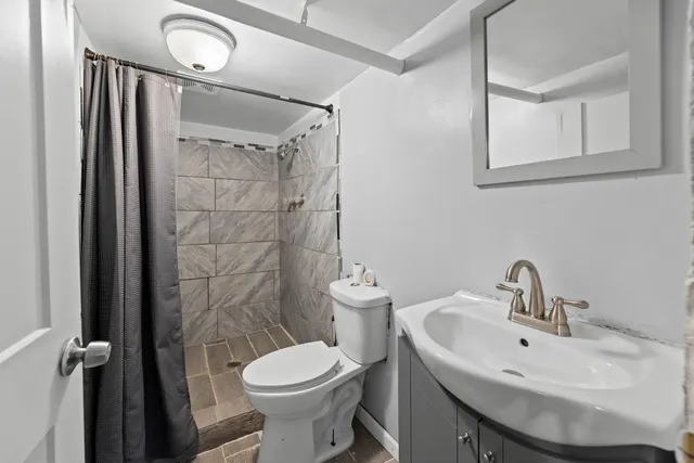 a bathroom with a sink toilet and shower