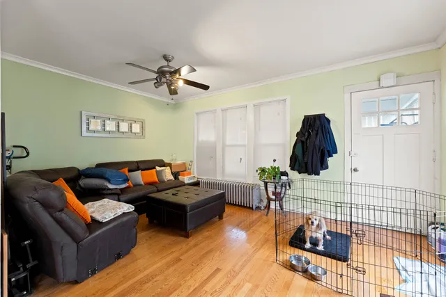 a living room with furniture a rug and a window