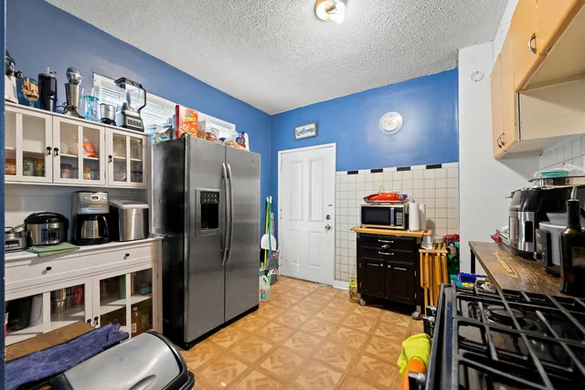 a kitchen with stainless steel appliances a refrigerator and a stove top oven