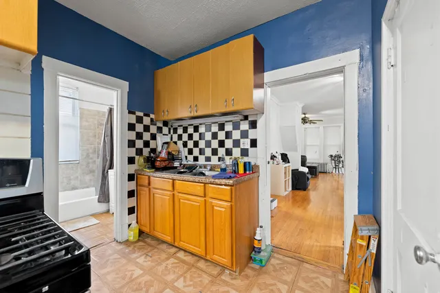 a kitchen with a sink and a stove top oven