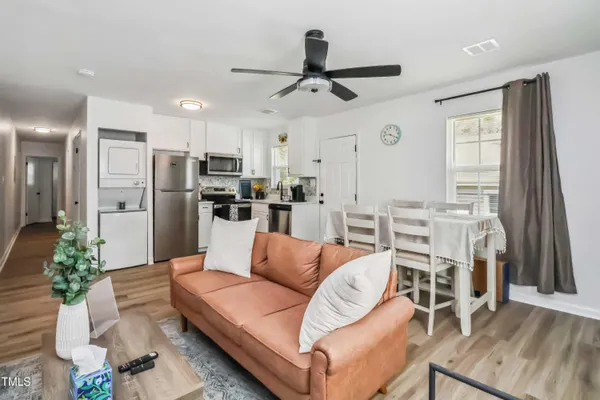 a living room with stainless steel appliances kitchen island granite countertop furniture and a kitchen view