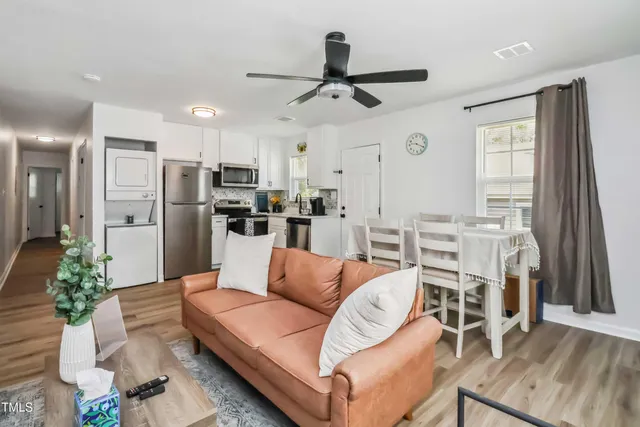 a living room with stainless steel appliances kitchen island granite countertop furniture and a kitchen view