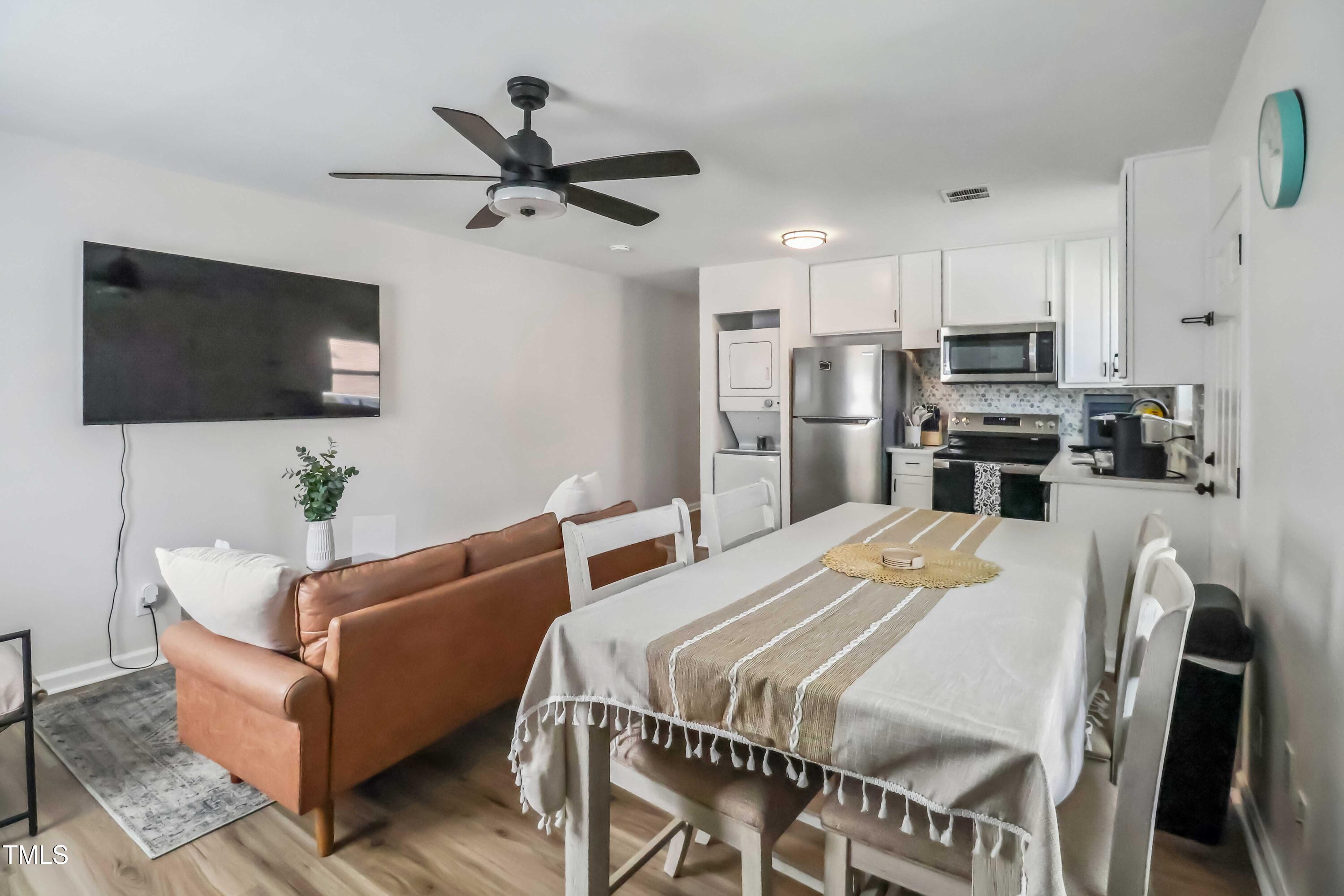 1300 South Street, Unit A Durham, NC 27707 - Photo 4 of 10 a living room with stainless steel appliances furniture a flat screen tv and a view of kitchen
