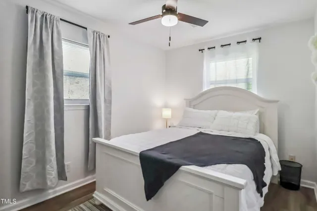 a bedroom with a large bed and a window