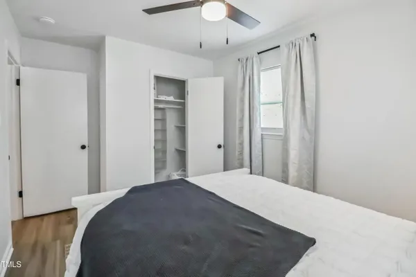 a bedroom with a bed and a chandelier